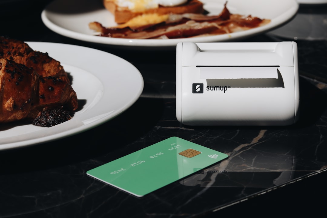 This photo showcases the SumUp Solo Printer card reader on a restaurant table, surrounded by food and coffee. Its perfect for small businesses and entrepreneurs, offering seamless payment processing in cafes and restaurants. Its sleek design and portability make it perfect for handling on-the-go transactions.